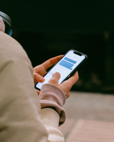 A person using a smartphone for texting, focusing on their hands and device screen.